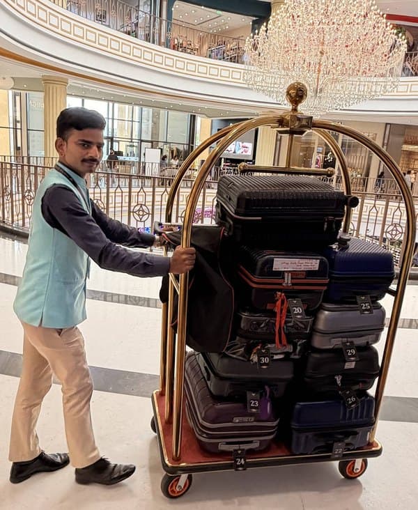 A Wheelerz porter with a trolley of guests’ luggage